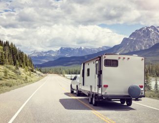 Caravan Or Motor Home Trailer On A Mountain Road